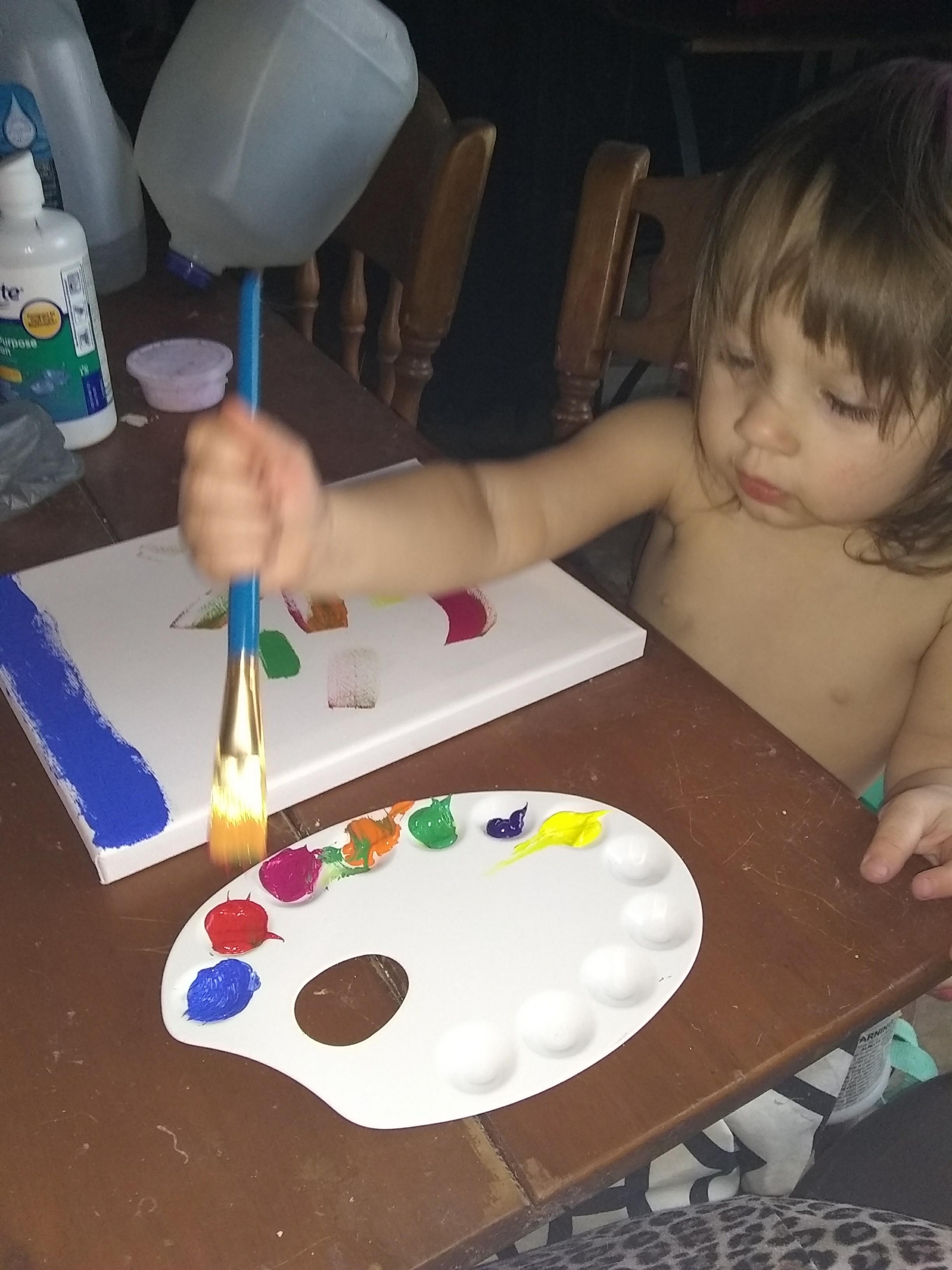 kid painting on canvas using oil painting set bought on amazon